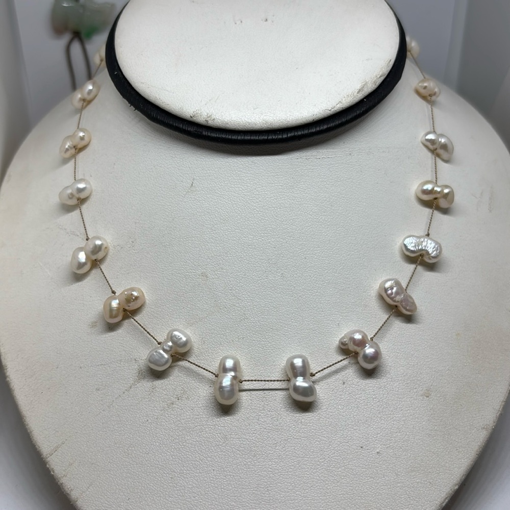12mm culture freshwater pearl tin cup necklace. Made with beige silk cord